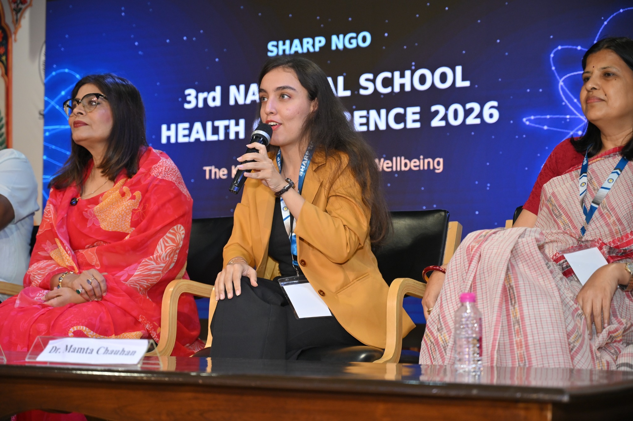 A panelist contributes to the discussion on designing for wellbeing, mental health and inclusion.
